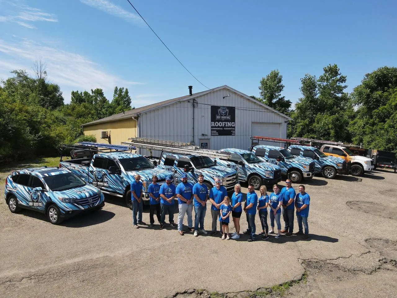 The HOF Roofing & Construction team and wrapped fleet in Northeast Ohio
