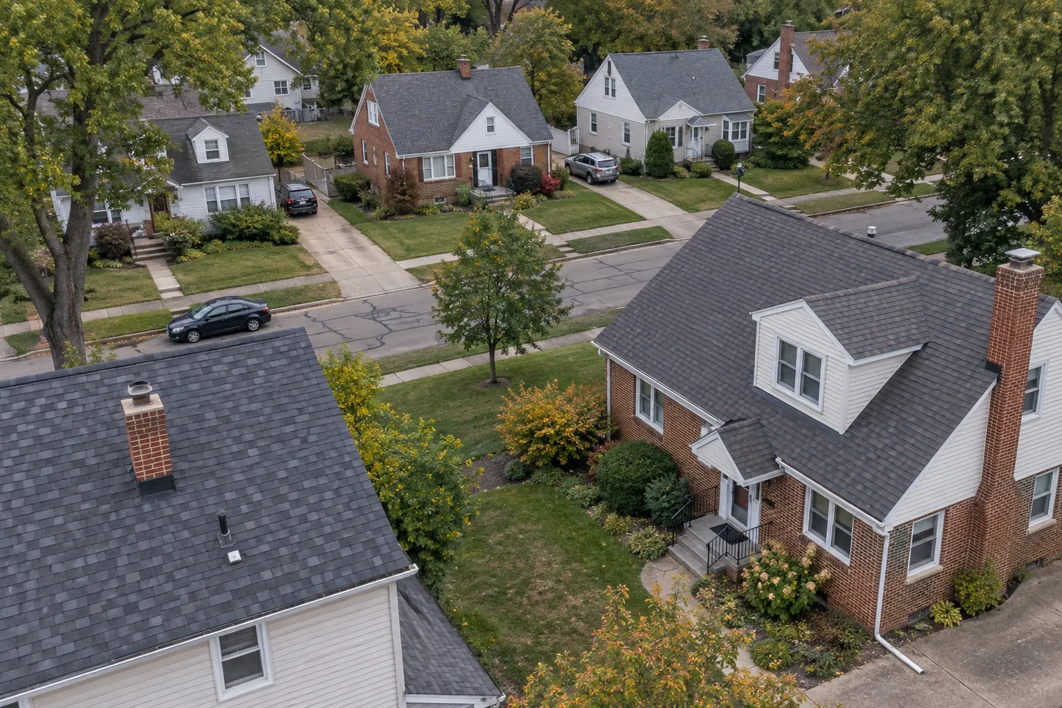 Elevated view of a representative Northeast Ohio neighborhood with brick homes and shingle roofs.